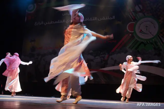 Palestinians, from Lebanon refugee camps, perform traditional dancing Dabka during a celebration at the Cultural Palace in the West Bank city of Ramallah on May 8,2011. Photo by Issam Rimawi