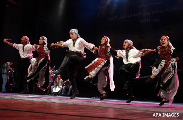 Palestinians, from Lebanon refugee camps, perform traditional dancing Dabka during a celebration at the Cultural Palace in the West Bank city of Ramallah on May 8,2011. Photo by Issam Rimawi