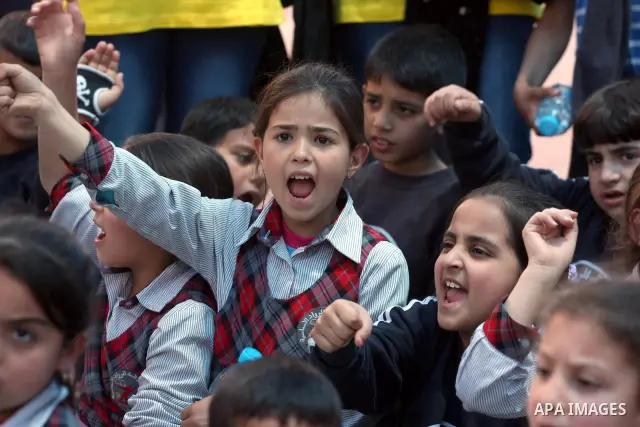 Palestinian children take part in a celebration to mark "Europe Day" in the West Bank city of Ramallah on May 9, 2011. France announced it would donate 10 million euros to the Palestinian Authority after Israel froze tax...