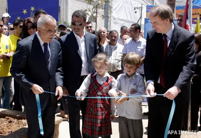 Palestinian Prime Minister, Salam Fayyad participates in a celebration to mark "Europe Day" in the West Bank city of Ramallah on May 9, 2011. France announced it would donate 10 million euros to the Palestinian Authority...