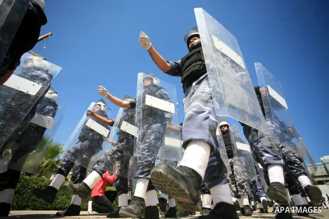 palestinian Hamas security forces march with their riot gear during a graduation ceremony at the Arafat police compound in Gaza City on May 10, 2011. Photo by Mohammed Othman