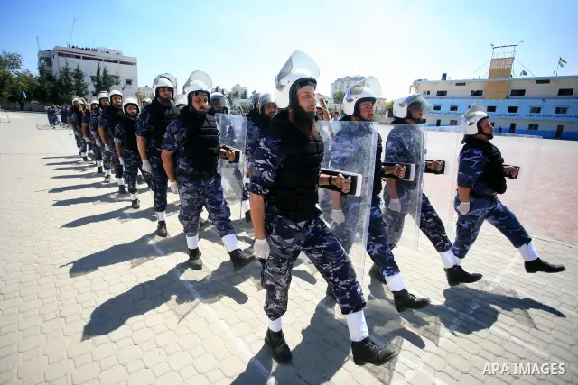 palestinian Hamas security forces march with their riot gear during a graduation ceremony at the Arafat police compound in Gaza City on May 10, 2011. Photo by Mohammed Othman