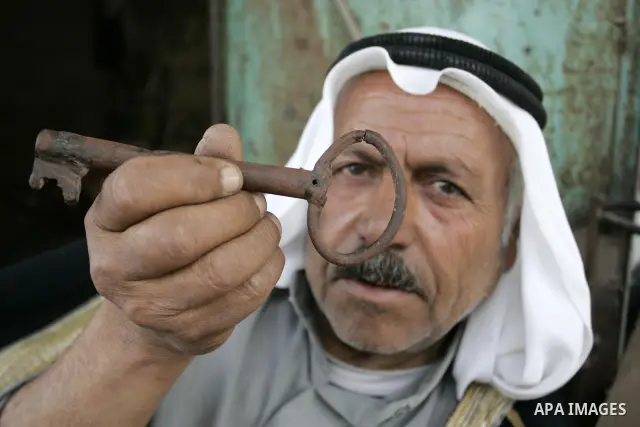 A Palestinian refugee, Ahmad Abd al-Ghani al-Akhras, 70 years old, from the Rafah refugee camp, holds up a key allegedly from his house in Wadi Hanin, now located in Israel on May 10, 2011. Palestinians commemorate the 6...