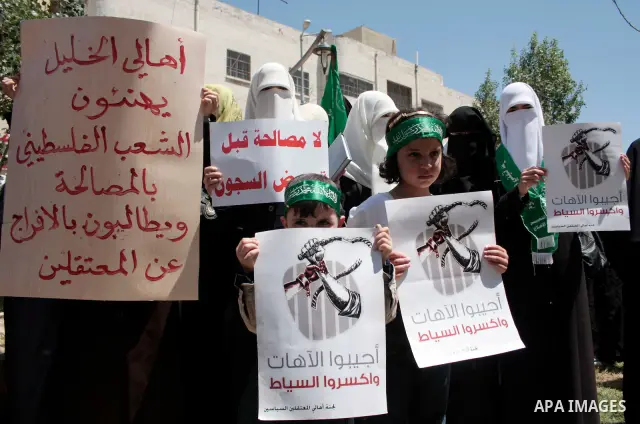 Palestinian women supporters of the Hamas Islamist movement take part in a rally calling for the release of Palestinians being held in West Bank and Gaza Strip jails in the West Bank city of Hebron on May 10, 2011. Photo...