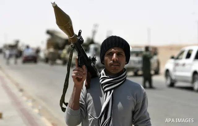 Libyan rebel fighters head towards the front line outside the Libyan eastern city Ajdabiya on May 10, 2011, where fighting between rebels and forces loyal to leader Moamer Kadhafi is ongoing. Photo by Wissam Nassar