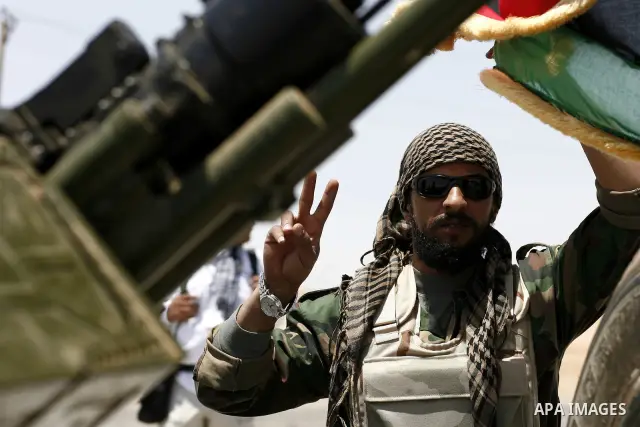 Libyan rebel fighters head towards the front line outside the Libyan eastern city Ajdabiya on May 10, 2011, where fighting between rebels and forces loyal to leader Moamer Kadhafi is ongoing. Photo by Wissam Nassar