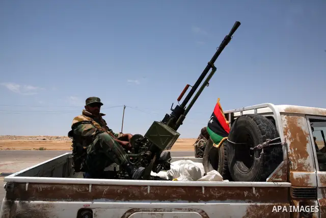 Libyan rebel fighters head towards the front line outside the Libyan eastern city Ajdabiya on May 10, 2011, where fighting between rebels and forces loyal to leader Moamer Kadhafi is ongoing. Photo by Wissam Nassar
