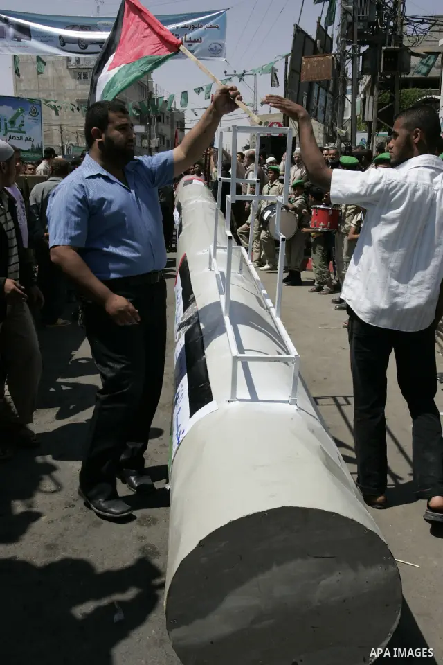 Palestinians gather around a giant key symbolising the keys to houses left by Palestinians in 1948 in the preparation to mark the 63rd anniversary of the "Nakba", Arabic for catastrophe, in the southern Gaza Strip town o...