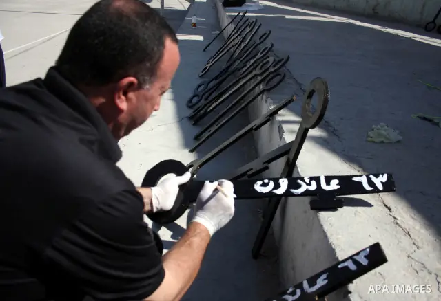Palestinians paint slogans on keys symbolizing the homes people lost in 1948 when the Jewish state of Israel was created, on May 11, 201 in the West Bank Qalandia refugee camp near Jerusalem, during a preparation to mark...