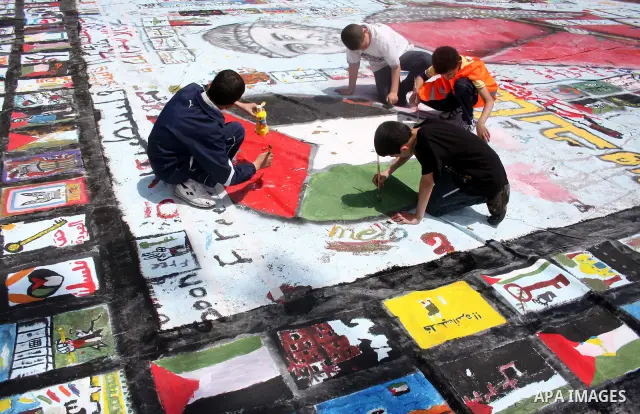 Palestinian students prepare a big mural to mark the 63th anniversary of "Nakba" (catastrophe), in the West Bank city of Ramallah, on May 12, 2011. Nakba means "catastrophe" in reference to the birth of the state of Isra...