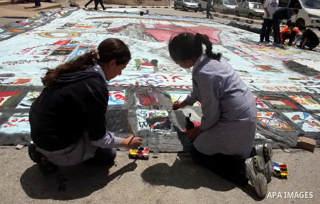 Palestinian students prepare a big mural to mark the 63th anniversary of "Nakba" (catastrophe), in the West Bank city of Ramallah, on May 12, 2011. Nakba means "catastrophe" in reference to the birth of the state of Isra...