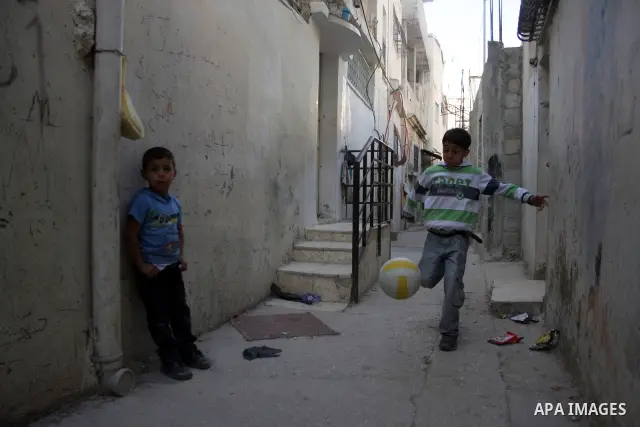 Palestinian children playing football in the Amari refugee camp, near Ramallah in the West Bank 12 May 2011. Nakba means "catastrophe" in reference to the birth of the state of Israel 63 years ago in British-mandate Pale...