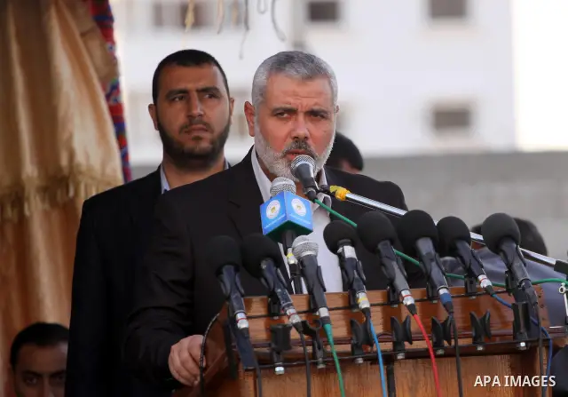 Palestinians prime minister in Gaza Strip, Ismail Haniyah watch Hamas security forces march during a graduation ceremony at the Ansar police compound in Gaza City on May 12, 2011. Photo by Mohammed Asad