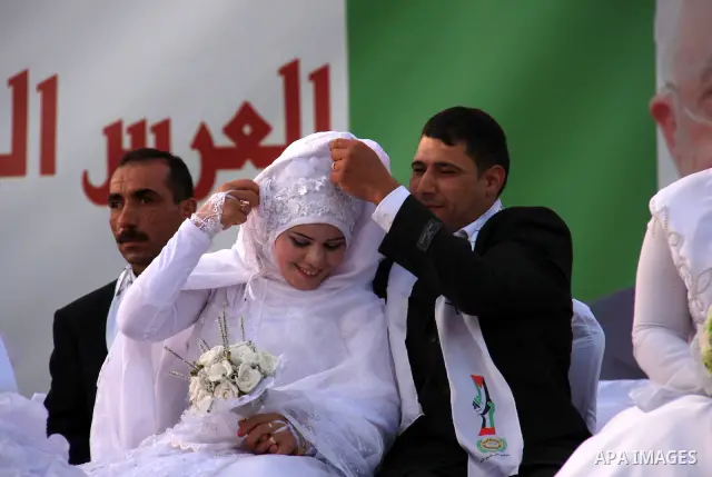 Palestinian brides and grooms take part in a mass wedding ceremony for disabled couples in the West Bank city of Nablus, Thursday, May 12, 2011. The wedding was sponsored by the United Arab Emirates and the Fatah movemen...
