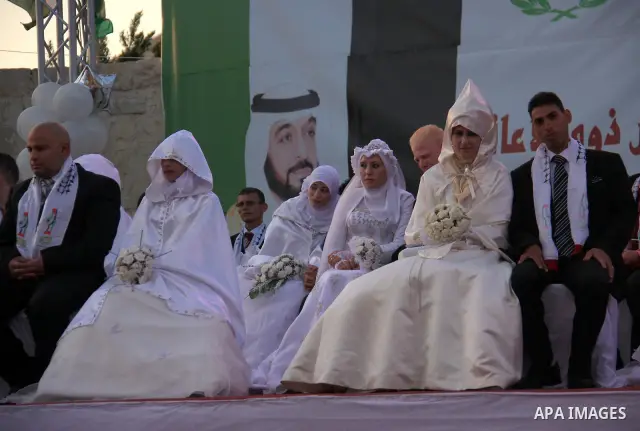 Palestinian brides and grooms take part in a mass wedding ceremony for disabled couples in the West Bank city of Nablus, Thursday, May 12, 2011. The wedding was sponsored by the United Arab Emirates and the Fatah movemen...