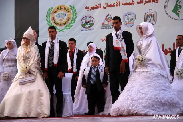Palestinian brides and grooms take part in a mass wedding ceremony for disabled couples in the West Bank city of Nablus, Thursday, May 12, 2011. The wedding was sponsored by the United Arab Emirates and the Fatah movemen...