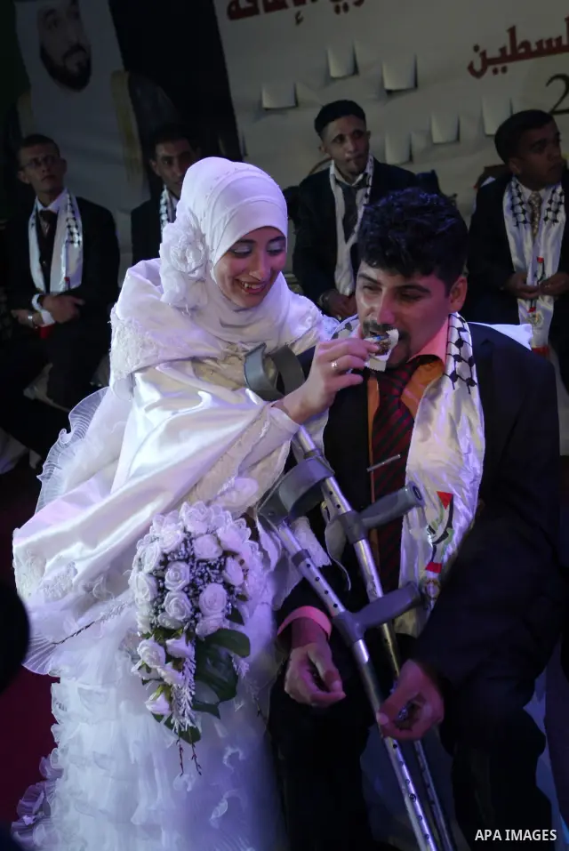 Palestinian brides and grooms take part in a mass wedding ceremony for disabled couples in the West Bank city of Nablus, Thursday, May 12, 2011. The wedding was sponsored by the United Arab Emirates and the Fatah movemen...