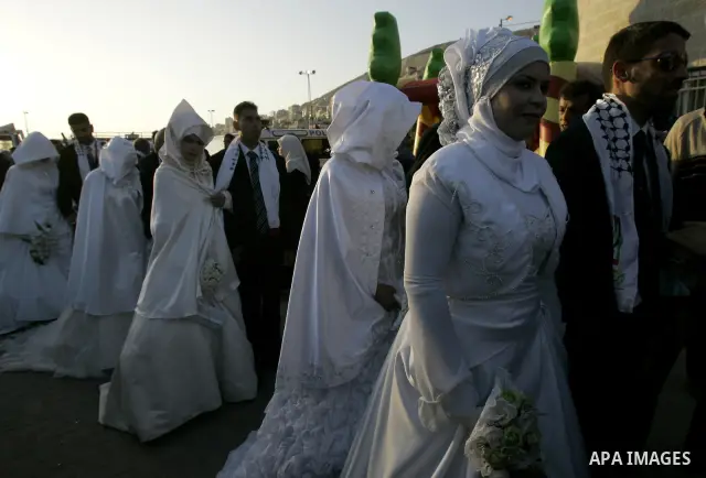 Palestinian brides and grooms take part in a mass wedding ceremony for disabled couples in the West Bank city of Nablus, Thursday, May 12, 2011. The wedding was sponsored by the United Arab Emirates and the Fatah movemen...