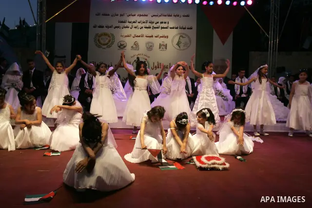 Palestinian brides and grooms take part in a mass wedding ceremony for disabled couples in the West Bank city of Nablus, Thursday, May 12, 2011. The wedding was sponsored by the United Arab Emirates and the Fatah movemen...