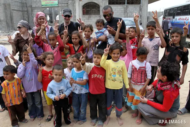 Italian peace activists who have a friendship with Vittorio Arrigoni play with children from al-Samoni family during their visit to Gaza Strip, in Gaza city on May 13,2011. Photo by Mohammed Asad