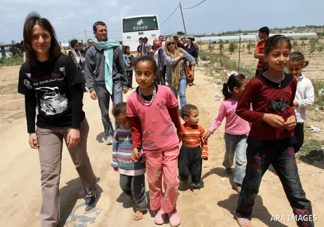 Italian peace activists who have a friendship with Vittorio Arrigoni play with children from al-Samoni family during their visit to Gaza Strip, in Gaza city on May 13,2011. Photo by Mohammed Asad