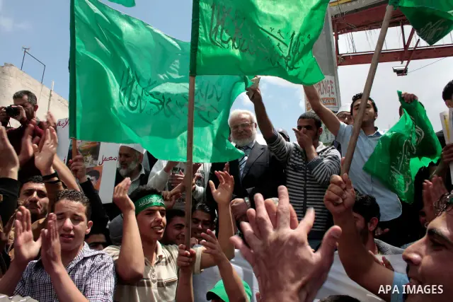 Palestinian parliament speaker, Aziz Dweik and Hamas members of the Palestinian Legislative Council (PLC) take part in a rally to mark the 63th anniversary of "Nakba" (catastrophe) on May 13, 2011 in the West Bank city o...