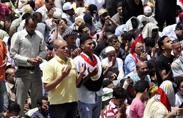 Egyptians attend Friday prayers at a rally at Cairo's Tahrir Square on May 13, 2011 during a protest calling for national unity after attacks on Egyptian churches, and solidarity with the Palestinians as they mark the "N...
