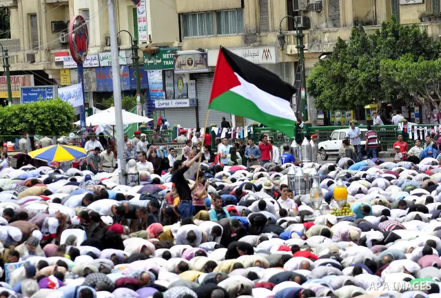 Egyptians attend Friday prayers at a rally at Cairo's Tahrir Square on May 13, 2011 during a protest calling for national unity after attacks on Egyptian churches, and solidarity with the Palestinians as they mark the "N...