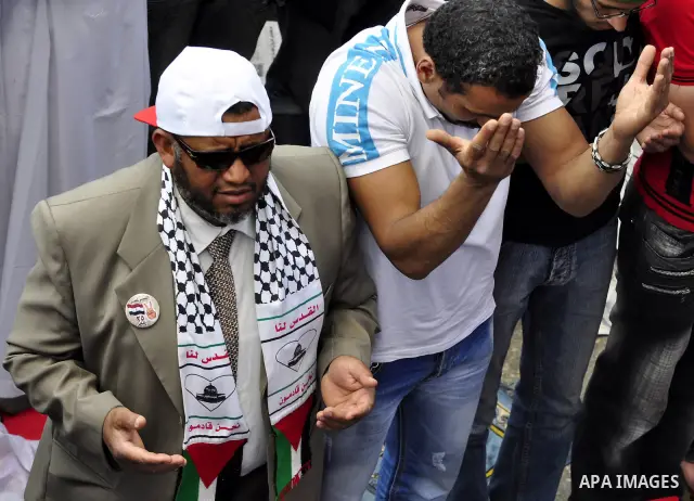 Egyptians attend Friday prayers at a rally at Cairo's Tahrir Square on May 13, 2011 during a protest calling for national unity after attacks on Egyptian churches, and solidarity with the Palestinians as they mark the "N...
