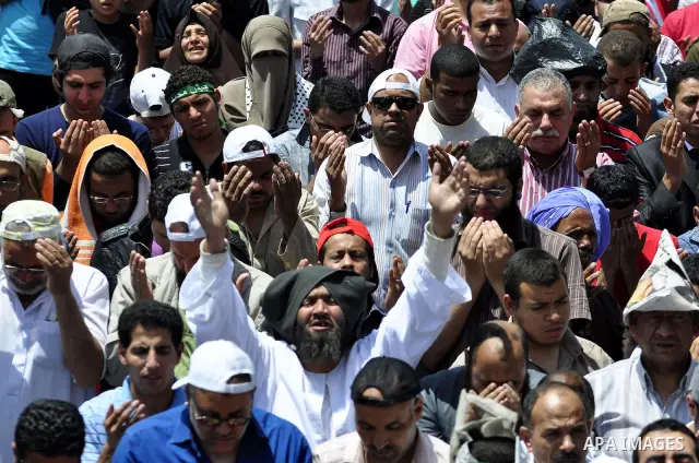 Egyptians attend Friday prayers at a rally at Cairo's Tahrir Square on May 13, 2011 during a protest calling for national unity after attacks on Egyptian churches, and solidarity with the Palestinians as they mark the "N...