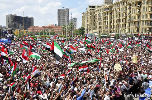 Egyptian demonstrators wave a Palestinian flag during a rally at Cairo's Tahrir Square on May 13, 2011 during a protest calling for national unity after attacks on Egyptian churches, and solidarity with the Palestinians...