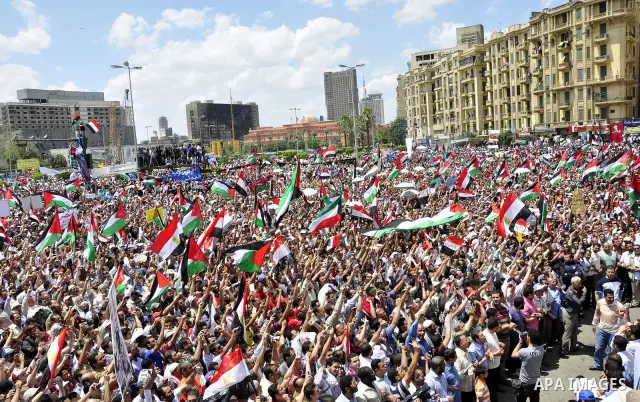 Egyptian demonstrators wave a Palestinian flag during a rally at Cairo's Tahrir Square on May 13, 2011 during a protest calling for national unity after attacks on Egyptian churches, and solidarity with the Palestinians...