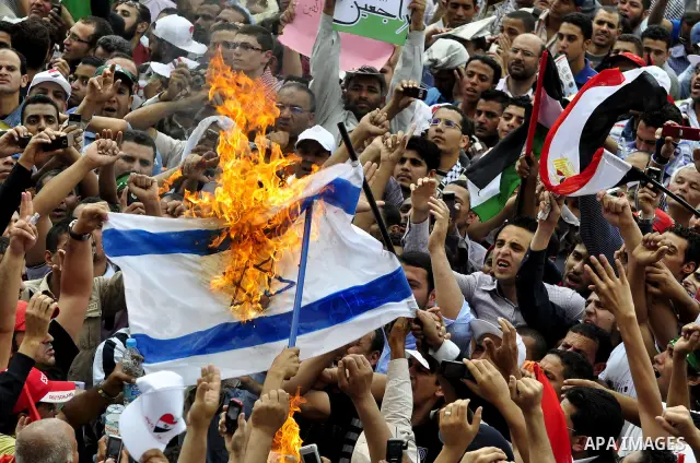 Egyptian demonstrators set fire in an Israeli flag during a rally at Cairo's Tahrir Square on May 13, 2011 during a protest calling for national unity after attacks on Egyptian churches, and solidarity with the Palestini...
