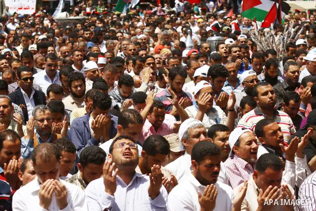 Egyptians attend Friday prayers at a rally at Cairo's Tahrir Square on May 13, 2011 during a protest calling for national unity after attacks on Egyptian churches, and solidarity with the Palestinians as they mark the "N...