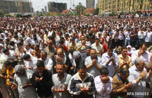 Egyptians attend Friday prayers at a rally at Cairo's Tahrir Square on May 13, 2011 during a protest calling for national unity after attacks on Egyptian churches, and solidarity with the Palestinians as they mark the "N...