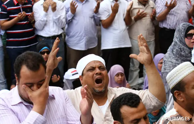 Egyptians attend Friday prayers at a rally at Cairo's Tahrir Square on May 13, 2011 during a protest calling for national unity after attacks on Egyptian churches, and solidarity with the Palestinians as they mark the "N...