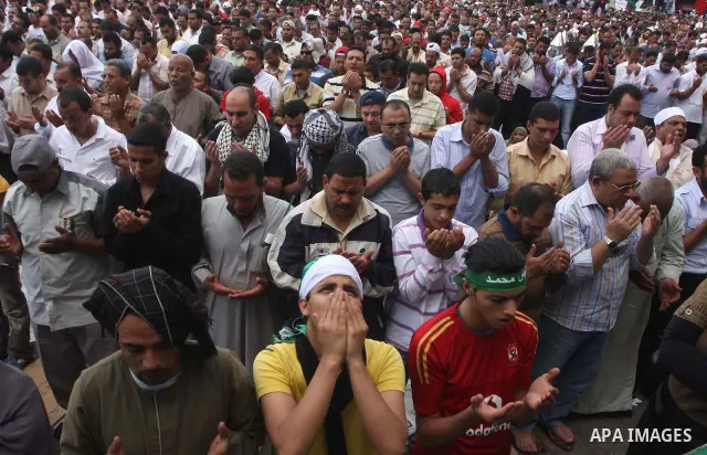 Egyptians attend Friday prayers at a rally at Cairo's Tahrir Square on May 13, 2011 during a protest calling for national unity after attacks on Egyptian churches, and solidarity with the Palestinians as they mark the "N...