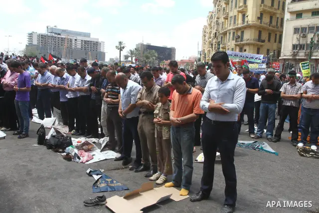 Egyptians attend Friday prayers at a rally at Cairo's Tahrir Square on May 13, 2011 during a protest calling for national unity after attacks on Egyptian churches, and solidarity with the Palestinians as they mark the "N...
