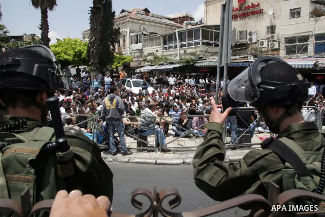 Palestinian Muslim worshipers perform Friday prayer outside Jerusalem's Old City on May 13, 2011 as Israeli police flooded the streets of Jerusalem, fearing violence as Palestinians began marking the "Nakba" or "catastro...