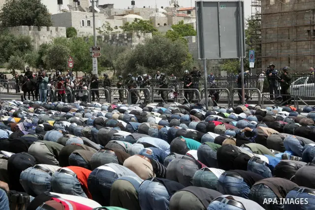 Palestinian Muslim worshipers perform Friday prayer outside Jerusalem's Old City on May 13, 2011 as Israeli police flooded the streets of Jerusalem, fearing violence as Palestinians began marking the "Nakba" or "catastro...