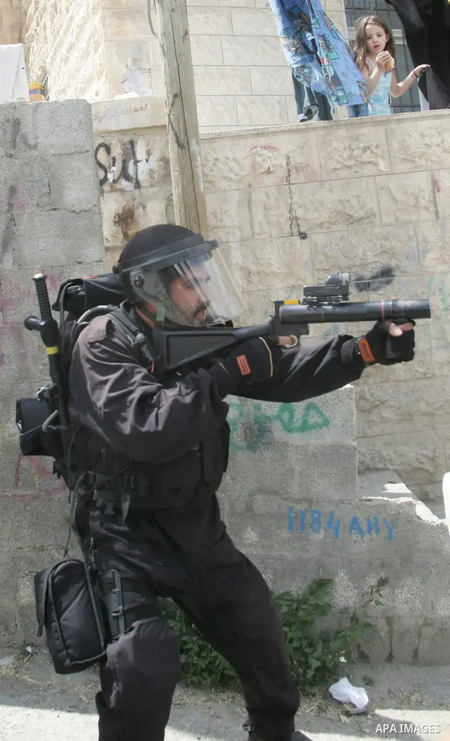 Israeli border policeman takes aim with a teargas grenade launcher in the East Jerusalem neighborhood of A-Tur, on 13 May 2011. Riots broke out in several flashpoints in East Jerusalem following the Friday Prayers. follo...