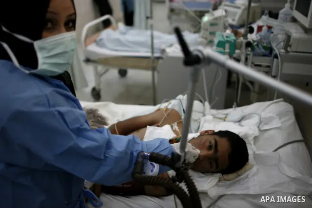 An injured Libyan rebel fighter receives treatment at a hospital after being evacuated from the besieged Libyan city of Misrata at the port in the eastern rebel stronghold of Benghazi on May 13, 2011. A ship carrying inj...