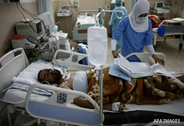 An injured Libyan rebel fighter receives treatment at a hospital after being evacuated from the besieged Libyan city of Misrata at the port in the eastern rebel stronghold of Benghazi on May 13, 2011. A ship carrying inj...