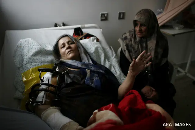 An injured Libyan woman receives treatment at a hospital after being evacuated from the besieged Libyan city of Misrata at the port in the eastern rebel stronghold of Benghazi on May 13, 2011. A ship carrying injured civ...