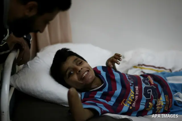 An injured Libyan boy, Mohammed al-Sheikh receives treatment at a hospital after being evacuated from the besieged Libyan city of Misrata at the port in the eastern rebel stronghold of Benghazi on May 13, 2011. A ship ca...