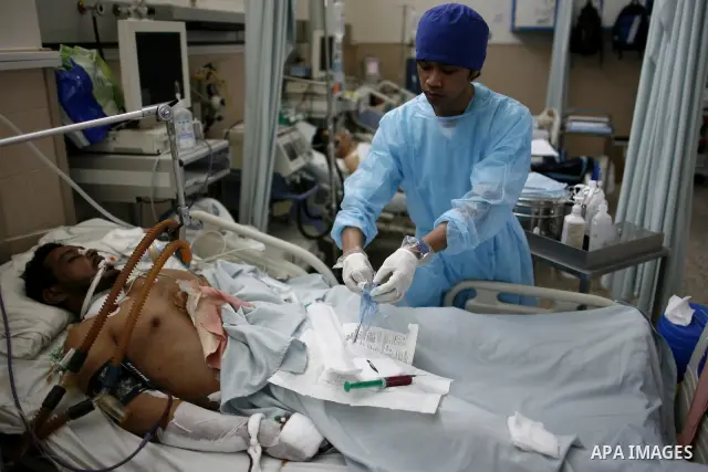 An injured Libyan rebel fighter receives treatment at a hospital after being evacuated from the besieged Libyan city of Misrata at the port in the eastern rebel stronghold of Benghazi on May 13, 2011. A ship carrying inj...