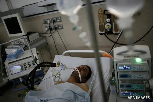 An injured Libyan rebel fighter receives treatment at a hospital after being evacuated from the besieged Libyan city of Misrata at the port in the eastern rebel stronghold of Benghazi on May 13, 2011. A ship carrying inj...