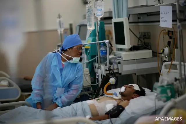 An injured Libyan rebel fighter receives treatment at a hospital after being evacuated from the besieged Libyan city of Misrata at the port in the eastern rebel stronghold of Benghazi on May 13, 2011. A ship carrying inj...