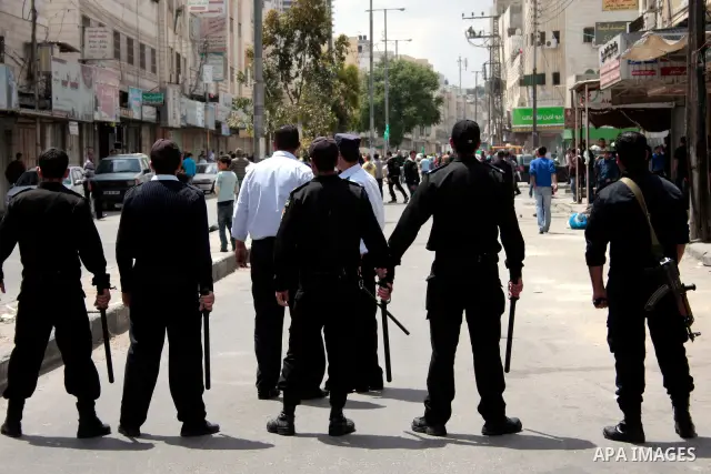 Palestinian security forces block the way of Hamas demonstrators who were trying to reach an Israeli-controlled checkpoint in the West Bank city of Hebron following a rally to mark the 63th anniversary of "Nakba" (catast...