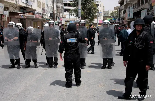 Palestinian security forces block the way of Hamas demonstrators who were trying to reach an Israeli-controlled checkpoint in the West Bank city of Hebron following a rally to mark the 63th anniversary of "Nakba" (catast...